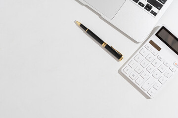 Flat lay, top view office white wooden table desk. Workspace with blank clip board, keyboard, office supplies,laptop,Notebook,pen,copy space on white background.