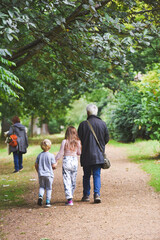 Fototapeta premium Grandparents with children on a day out for a walk