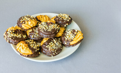 Biscuits covered with chocolate and nut crumbs view from above