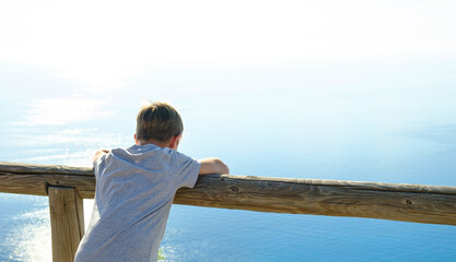 10 year's boy enjoying the view of the beautiful sea. 