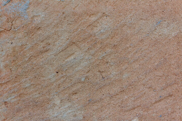 Polished stone texture with orange details.  Copy space.