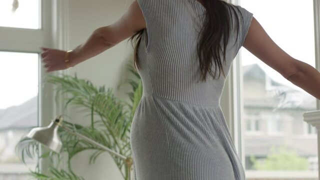 Pregnant woman - 25 weeks pregnant dancing on table in living room - having fun 4