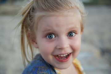 Candid portrait of toddler girl with funny face expression