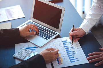 business people photo The feasibility of the project is being analyzed. with documents placed on the table and laptop