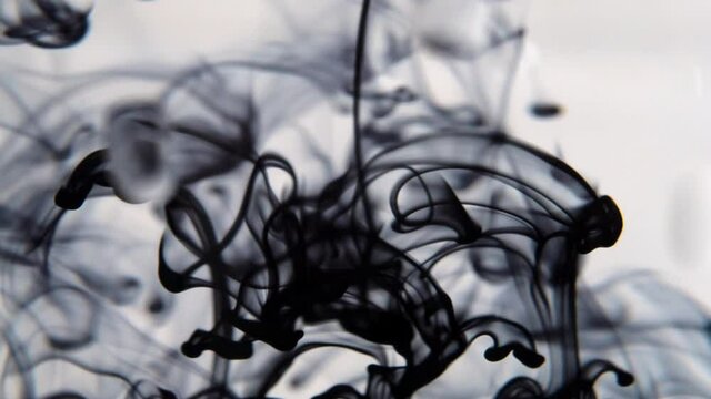 black color paint ink drops in water  video. Inky cloud swirling flowing underwater. 4k