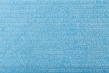 Blue flossy towel texture close up. Fluffy cozy bathrobe fabric with horizontal lines. Textured textile background with space for text