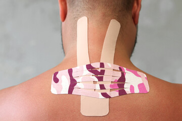 Kinesiology taping.Close up view of kinesiology tape on patient neck. Kinesiology, physical therapy, rehabilitation concept. - obrazy, fototapety, plakaty
