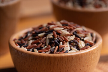 Jasmine Brown Rice in wooden bowl with copy space, Thai rice varieties Top view