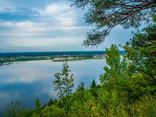 Kokshaysk, Russia - August, 09 2021: Panoramic view of the village of Kokshaisk from the opposite high shore of the Volga River