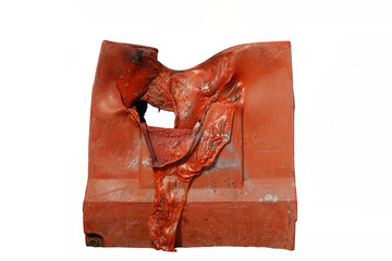 A red plastic block is badly burnt, melt and deformed by fire.  Caution for outdoor material...