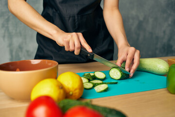 Woman in black apron lunch at home vegetarian food isolated background