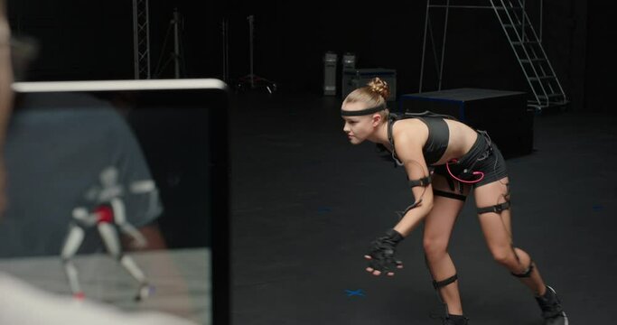 woman wearing motion capture suit in studio actor performing animal movements wearing mo-cap suit for 3d character animation for virtual reality technology