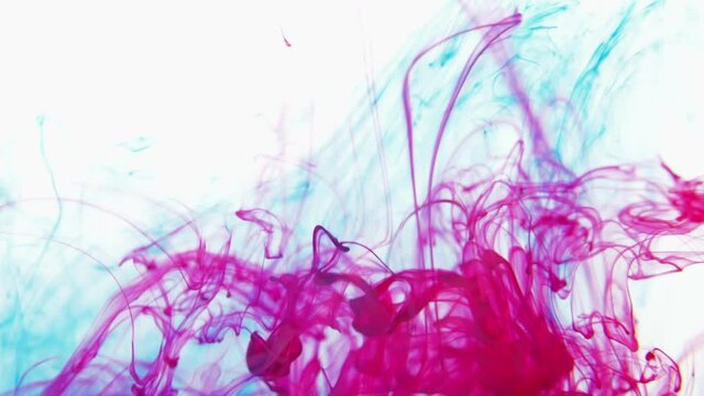 red and blue color paint ink drops in water.  Inky cloud swirling flowing underwater. 4k