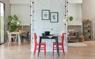 Black kitchen table, chair and plate in the white brick wall, modern living room background, working table, bookshelf concept, home living room interior style.