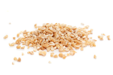 Micro close-up and details of Organic Indian broken wheat (dalia or daliya ) (Triticum) roasted  isolated over white background.
