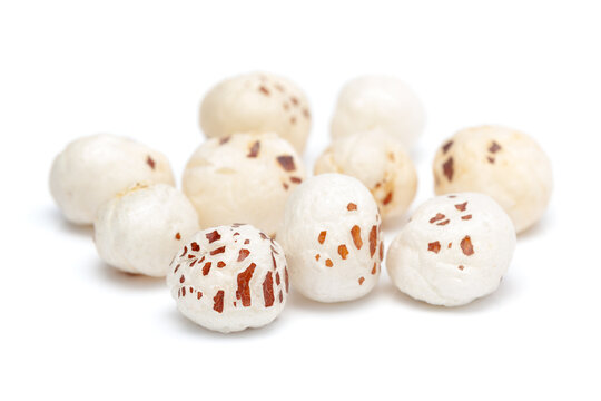 Micro close-up and details of Organic Indian makhane (puffed lotus seed or Fox nuts) isolated over white background.
