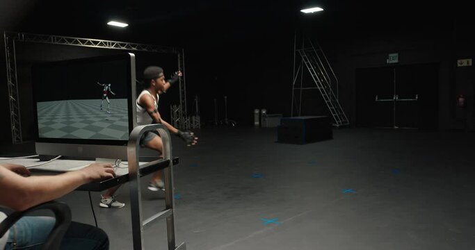 man wearing motion capture suit in studio performing backflip gymnastics actor wearing mo-cap suit for 3d character animation for virtual reality technology