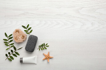 Flat lay composition with pumice stone on white wooden background. Space for text