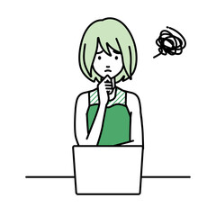 デスクで座ってPCを開いて困っているドレスの女性