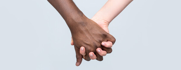 White Woman, African man Holding Hand Friendship Symbol. African Peace Symbol. Mixed race couple...
