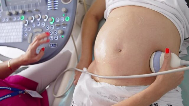 Pregnant Woman Having 4D Ultrasound Scan. Pregnancy and Healthcare concept. Prenatal Screening.