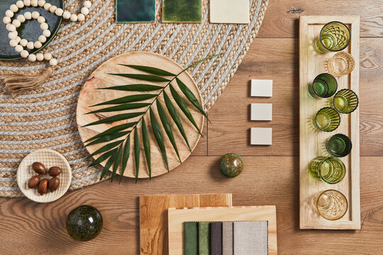 Flat lay of creative architect moodboard composition with samples of building, orange textile and natural materials and personal accessories. Top view, template.