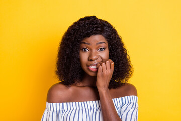 Fototapeta na wymiar Portrait of attractive unsure uncertain nervous girl worrying biting nails fear isolated over bright yellow color background