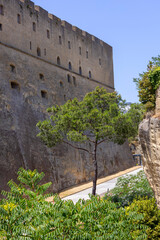 The scenic road among the rocks on the Vomero Hill leading to medieval Castel Sant'Elmo, Naples, Italy