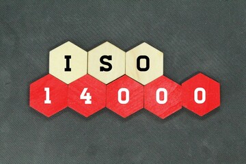 red hexagon and wood with the word iso 14000 - obrazy, fototapety, plakaty