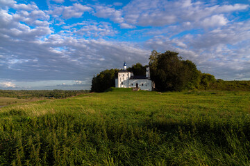 Saint Nicholas Church in Gorodishche  (Nikolskaya church) on Truvorov Gorodishche on a sunny summer evening with clouds. Stary Izborsk, Pskov region, Russia