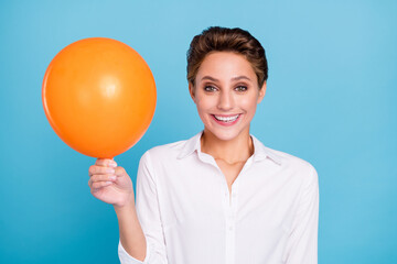 Photo of funny blond millennial lady hold balloon wear shirt isolated on blue color background