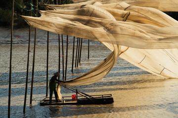 A fisherman hangs giant fishing nets to dry in Xiapu, China's Fujian province