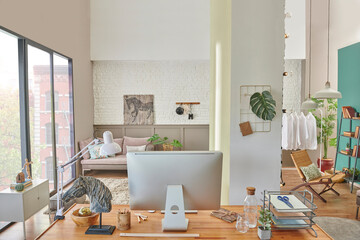 Working table and decorative living room style, modern home concept with laptop notebook poster and armchair decor.