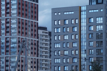 Horizontal full-color photo. Urban texture. Glass and concrete with reflections in the evening...