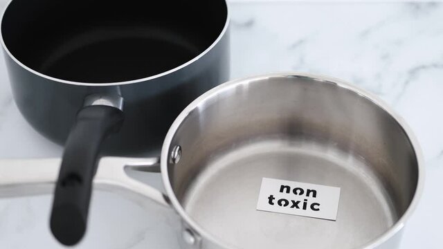 healthy cooking concept, stainless steel vs non stick saucepan side by side with Non Toxic label on the first one