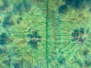 Watercolor abstract illustration. Nicely crumpled fabric. Knotted batik. Abstract painting. Spray paint on fabric. Blue stains of paint on a green background.
