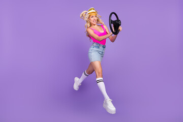 Full length body size view of pretty nervous girl jumping horn steering wheel isolated over bright...
