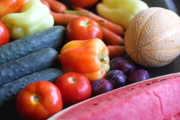 Various colorful summer fruit and vegetable on dark background. Selective focus.