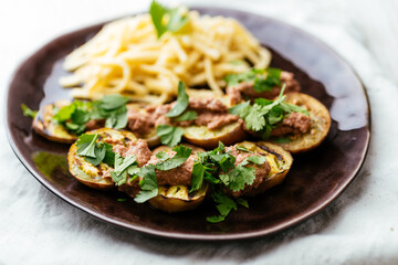 Plate with grilled eggplant slices served with a walnut sauce