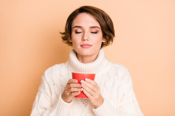 Photo portrait of female student enjoying hot coffee aroma drinking tasty beverage isolated on pastel beige color background