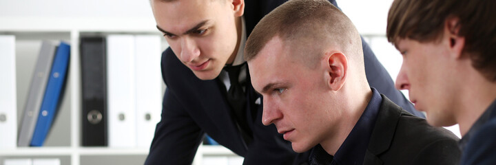 Obraz premium Group of people in office look in laptop