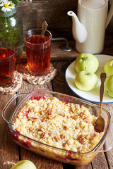 Peach and plum streusel pie. Walnuts, tea, chamomile, side view, wooden background, rustic.