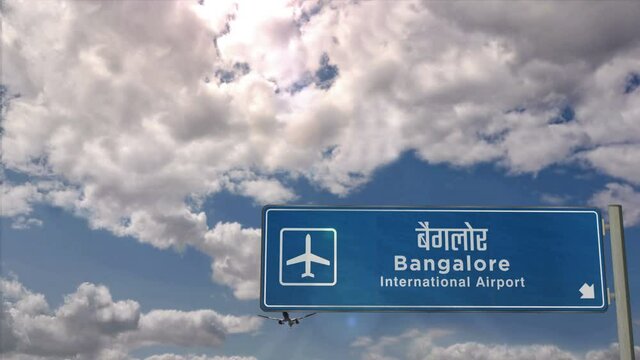 Jet airplane landing in Bangalore, India. City arrival with airport direction sign. Travel, business, tourism and transport concept.