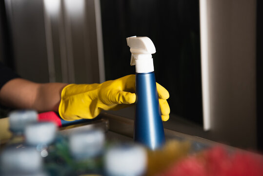 Cropped View Of Maid In Rubber Glove Reaching Spray Bottle