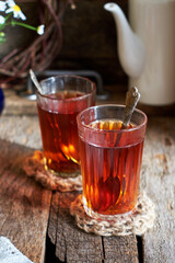 tea in a glass on a wooden table. Side view. Rustic.