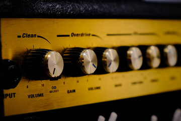 Close-up of the audio mixer, an electric guitar or bass amplifier.