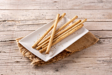 Breadstick grissini snack on rustic wooden table