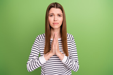 Photo of young unhappy sad upset woman ask beg please pray negative isolated on green color...