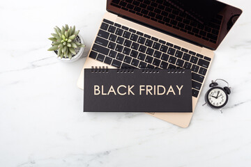 Black friday concept with laptop on marble table