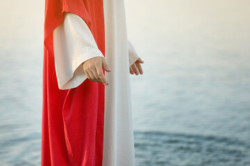 Jesus Christ near water outdoors, closeup. Space for text